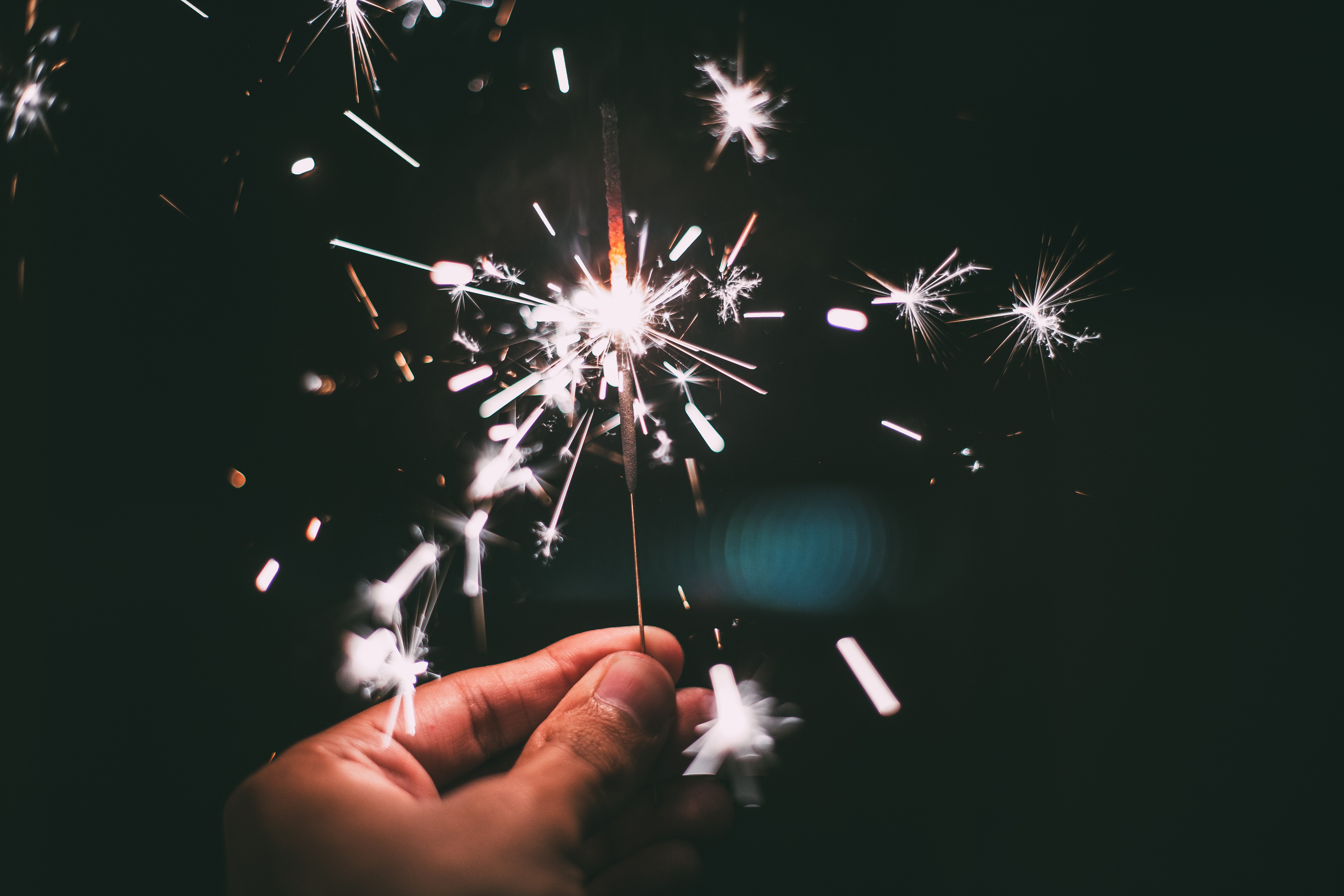 A hand holds a sparkler