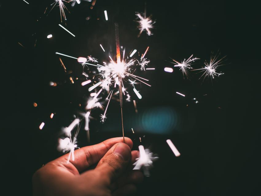 A hand holds a sparkler