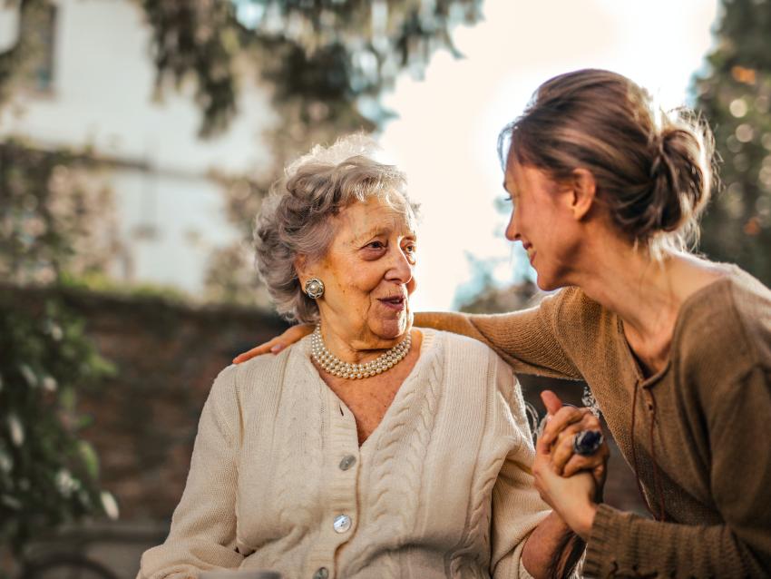 An older woman talks to a younger woman