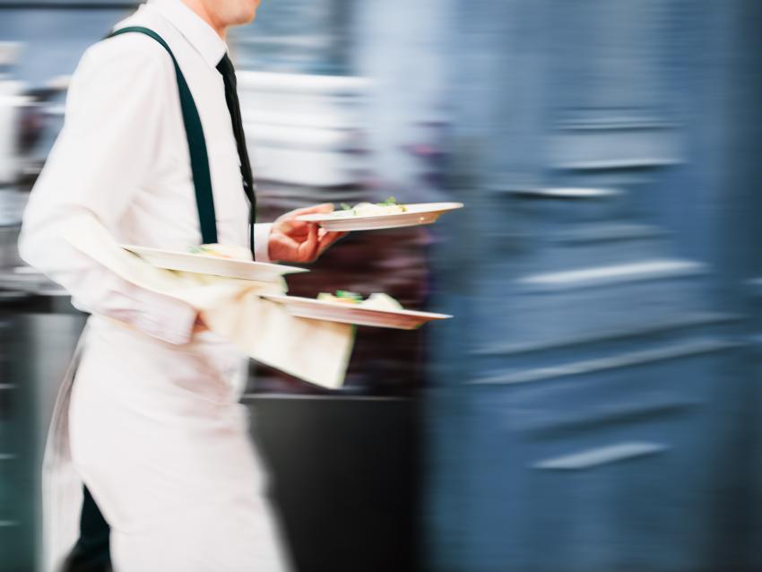 Waiter Serving In Motion On Duty in Restaurant Long Exposure